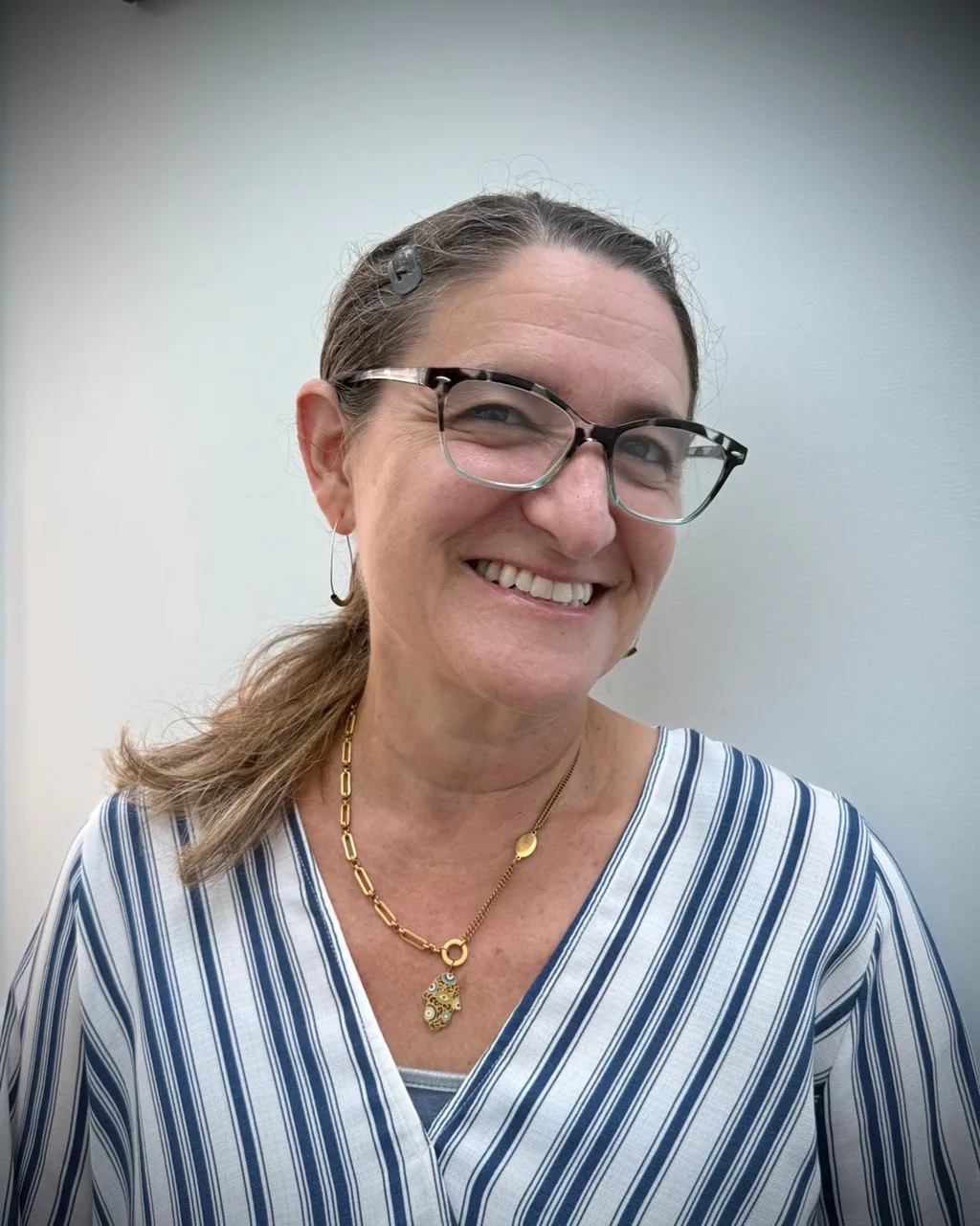 Anna Talamo, LMFT, EMDR therapist in Albany, California, smiling in a blue and white striped top